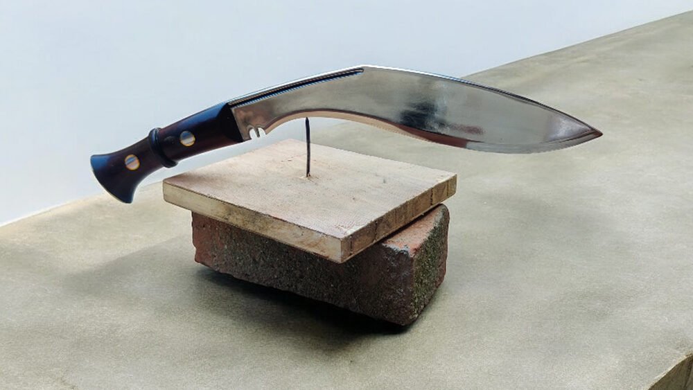 12 inches Mark 4 Kukri by himalayan blades balanced at the tip of the nail